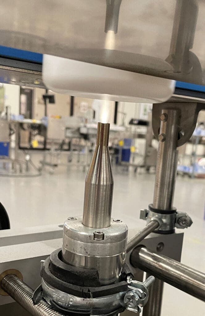 biovation-labs-blown-ion-plasma-discharge-on-bottle Biovation Labs plasma treats bottles prior to printing lot codes.