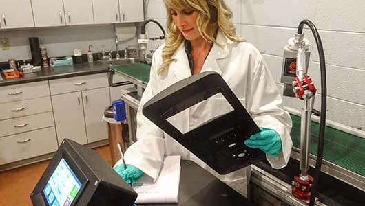 lab technician recording surface treating lab results