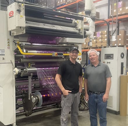 Sev-Rend's Jesse Porterfield (Left) with Enercon's Aaron Hootkin (Right) in front of Printing Press and Enercon Corona Treater.