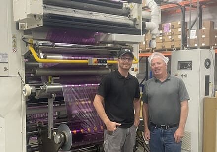 Sev-Rend's Jesse Porterfield (Left) with Enercon's Aaron Hootkin (Right) in front of Printing Press and Enercon Corona Treater.